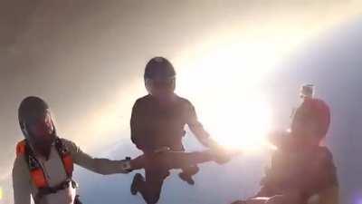 Two skydivers collide mid-air, knocking one of them unconscious. Camera man proceeds to pull some mission impossible shit and saves his life.