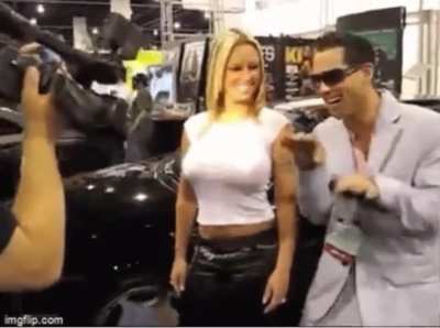 Is there a reason this arouses me? | Blonde woman flexing her boobs at a car show.