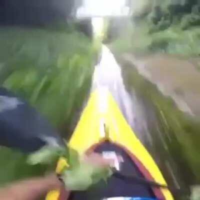 kAYAKinG PeRSOn miStAKES rivuLet For A riVeR