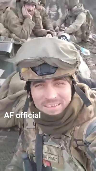 Ukrainian infantry raise a smile as they ride their BMP-1 IFV across the open steppe.