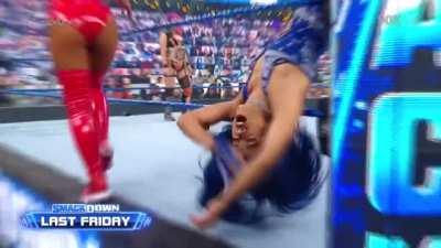 Sasha groans as Carmella knocks her out