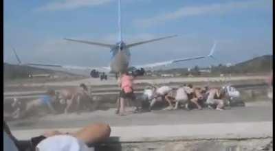 A bunch of crazy people trying to get burned by a jet airplane engines