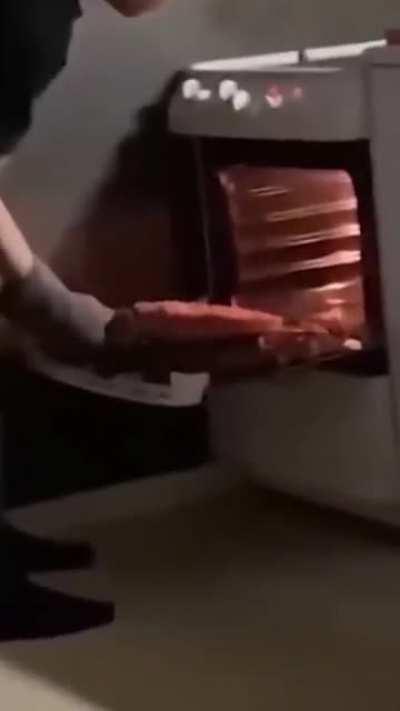 WCGW trying to take the pizza out of the oven with one hand.