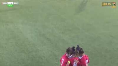 Rival players shield Jordanian footballer from view after her hijab comes loose during match