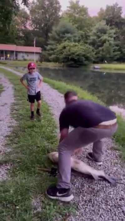 Man gets nut tapped by a giant Asian carp while trying to handle it
