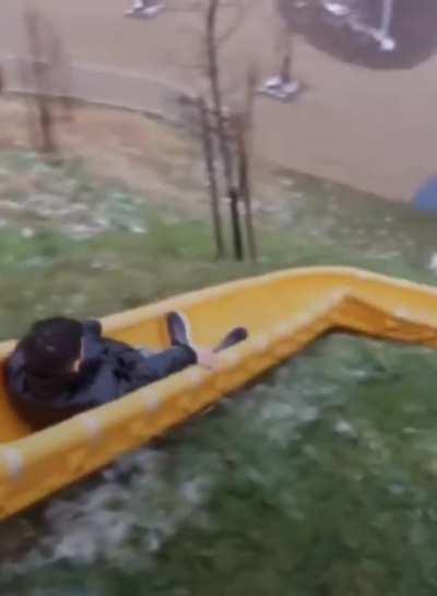 Sliding on this crazy looking playground slide
