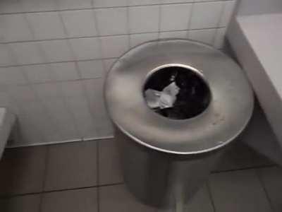 Dude pissing all over a (presumably public) bathroom. Wtf