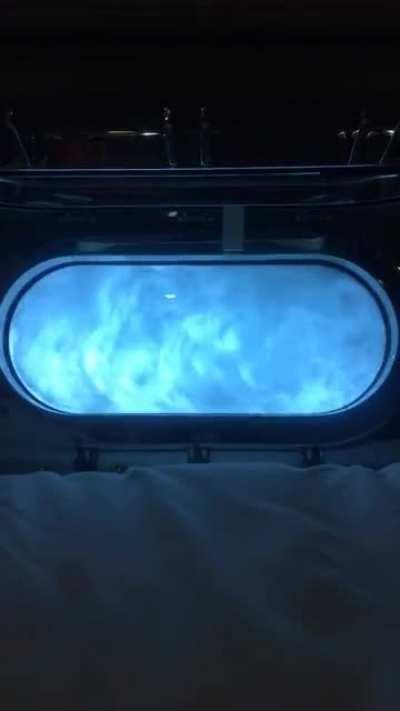 OC Porthole view while sailing off the Amalfi coast