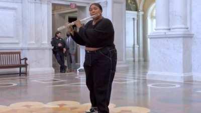 Lizzo playing a 200 year old flute in the library of congress