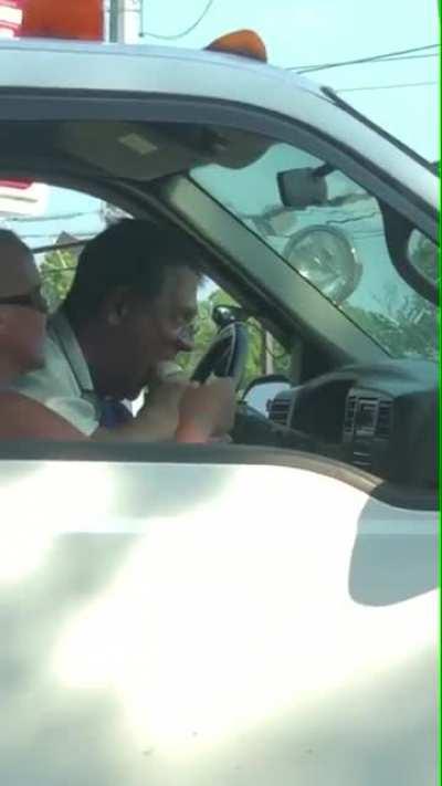 Guy enjoying a spicy foot burrito in traffic.