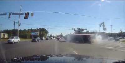 Truck driver changes lanes and flips over onto passenger car.