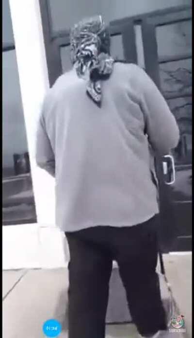 Man walks into police station, wearing a mask, and carrying an assault rifle.