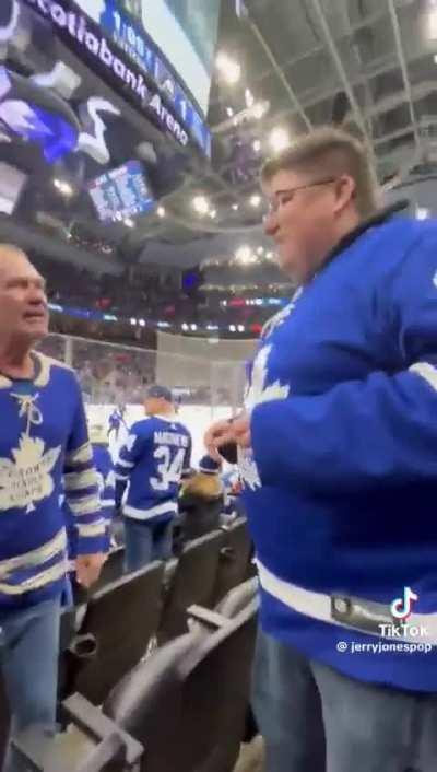 Dude throws another guy's hat onto the ice at a Maple Leafs game, proceeds to post it online