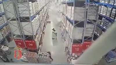 Industrial shelves piled with vodka and beer crash down in Russian warehouse.