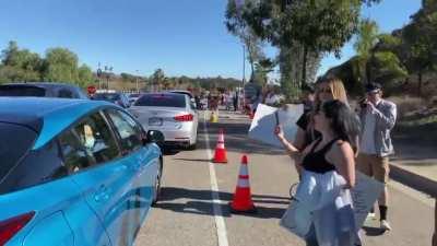 Antivax covidiots harassing people waiting in line at a vaccination center