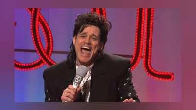 Поёт Джим Керри.