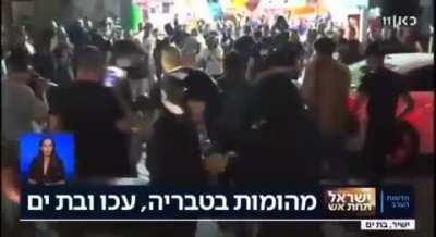 A Group of Israeli settlers brutally assaulting Palestinian young man in 