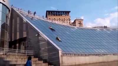 Slide down a glass roof, get knocked out