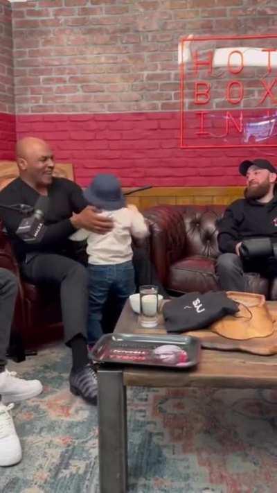 Mike Tyson meeting Hasbulla in his podcast studio. Hasbulla is a 20 year old man, but I don't think the information was conveyed to Mike...