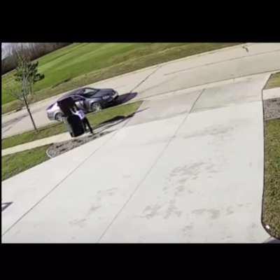 Struggling with putting in the trash can on a windy day