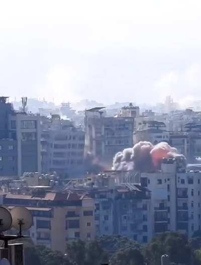 Photographer captures moment building in Beirut stronghold hit in Israeli airstrike