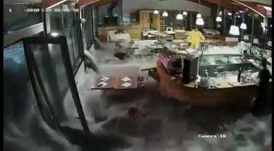 Wave washes through the windows of an Italian restaurant!