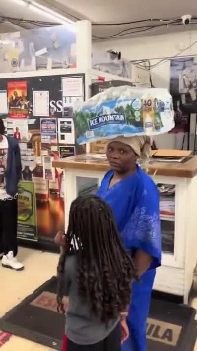 Woman throws lunges at man recording her for carrying water African style