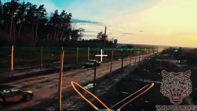 Fiber optic drone maneuvers under a Ukrainian anti-drone net and hits a pickup truck