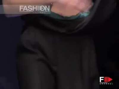 Boobs pop out. Can't tell if she's annoyed or that's just her face.