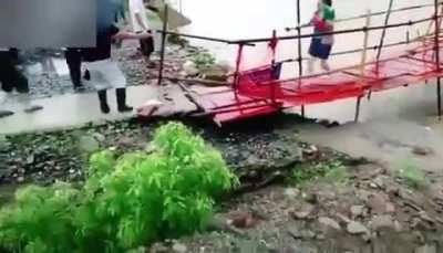 Woman just made it across failing bridge.