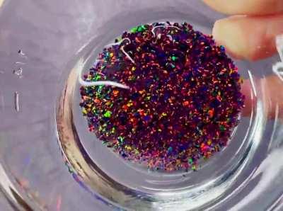 Synthetic black opal that I crushed, sifted, and cleaned.