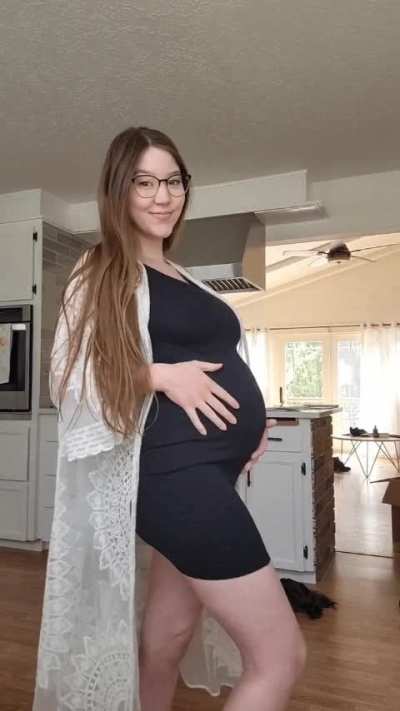 I feel so cute in this tight dress with a big pregnant belly