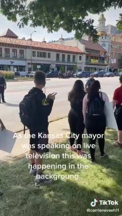 “There’s a police officer with their knee on someone’s back right now!”