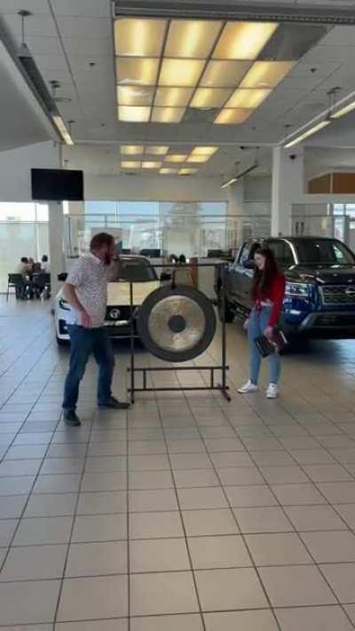 Making her kick the gong placed right in front of the brand new car