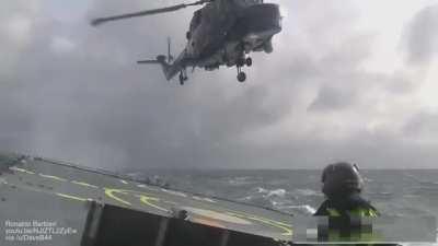 Landing a helicopter on a small ship in rough sea