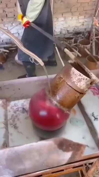 production of a ball with red natural stone