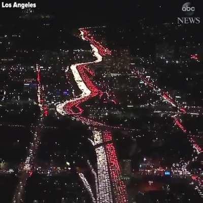 Massive traffic jam at night on I-405 through Los Angeles creates a beautiful view from above