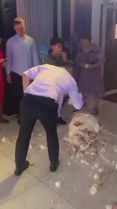 They accidentally dropped their wedding cake, but her husband's reaction confirms she's got a good one.