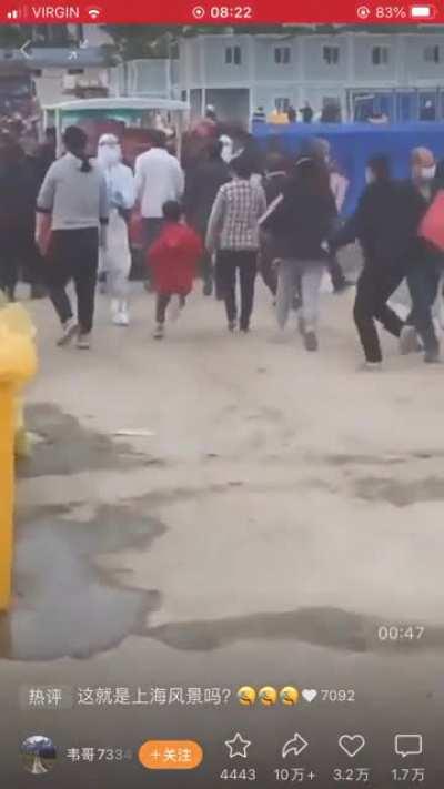 People grabbing boxes from a shanghai quarantine facility, slowly playing out like lord of the flies, even stormtroopers taking food