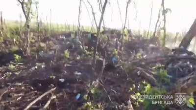 Ukrainian soldiers of the Presidential Brigade assault a Russian trench. Unknown direction, Ukraine. 22 July 2023.
