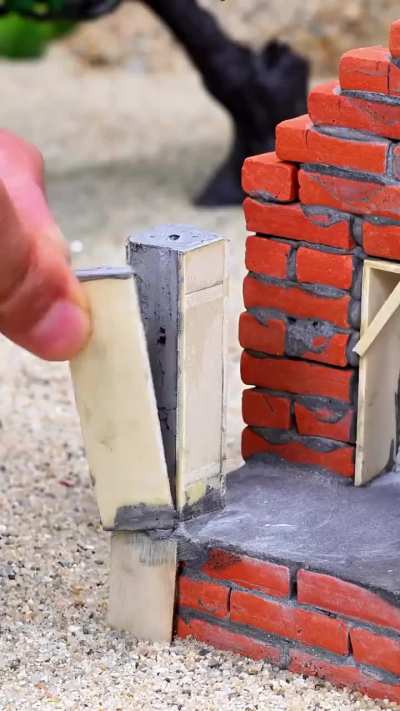 Miniature home built brick by tiny brick.