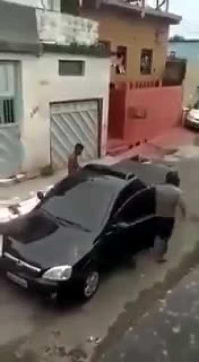 Guy hits the hood of a car and gets punched in the face.