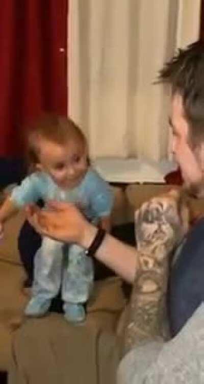 Dad pretends to eat toddlers sock.