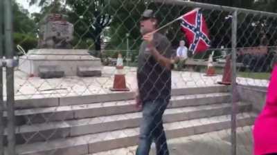 Shelby County Commissioner Tami Sawyer tries to give an interview to the media about the removal of a monument with the remains of Confederate General, slave trader and early leader of the KKK, Nathan Bedford Forrest as a member of the construction crew h