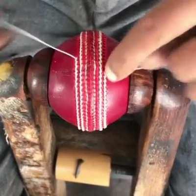 Making of a cricket ball in a factory.