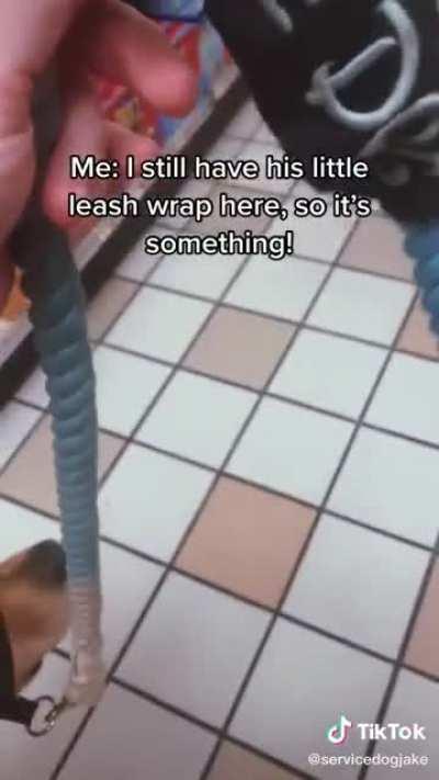 Lady with a service dog answers some questions from a curious store clerk