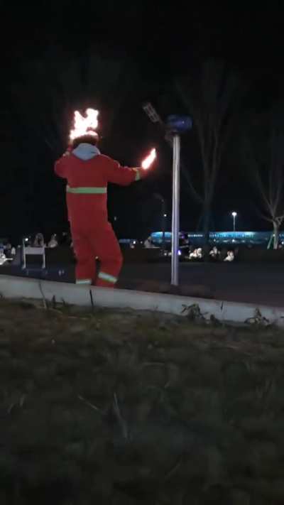 Spectators freak and firefighters (almost) react to a performer who lights head on fire.. 