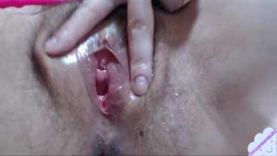 Girl with hairy cunt tease her pussy with pink vibrator close up