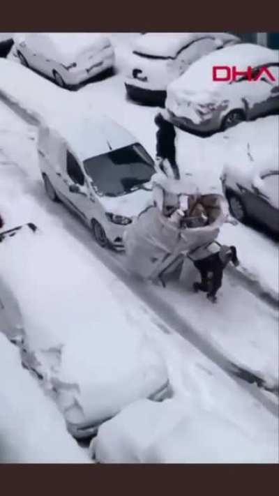 This driver helping the man pull that huge container of paper.