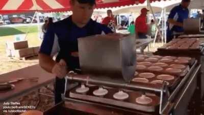 Half-human, half-machine. Watch as pancakes are made in bulk.